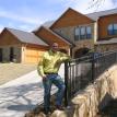 Clint Jarrett infront of Custom Home he designed and built.