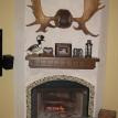 Stucco fireplace with glass tile accent. Custom rock hearth and Oak mantel